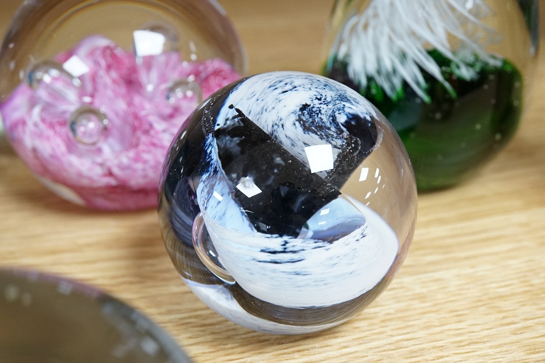 A collection of glass paperweights to include Caithness and millefiori examples, largest 10cm high